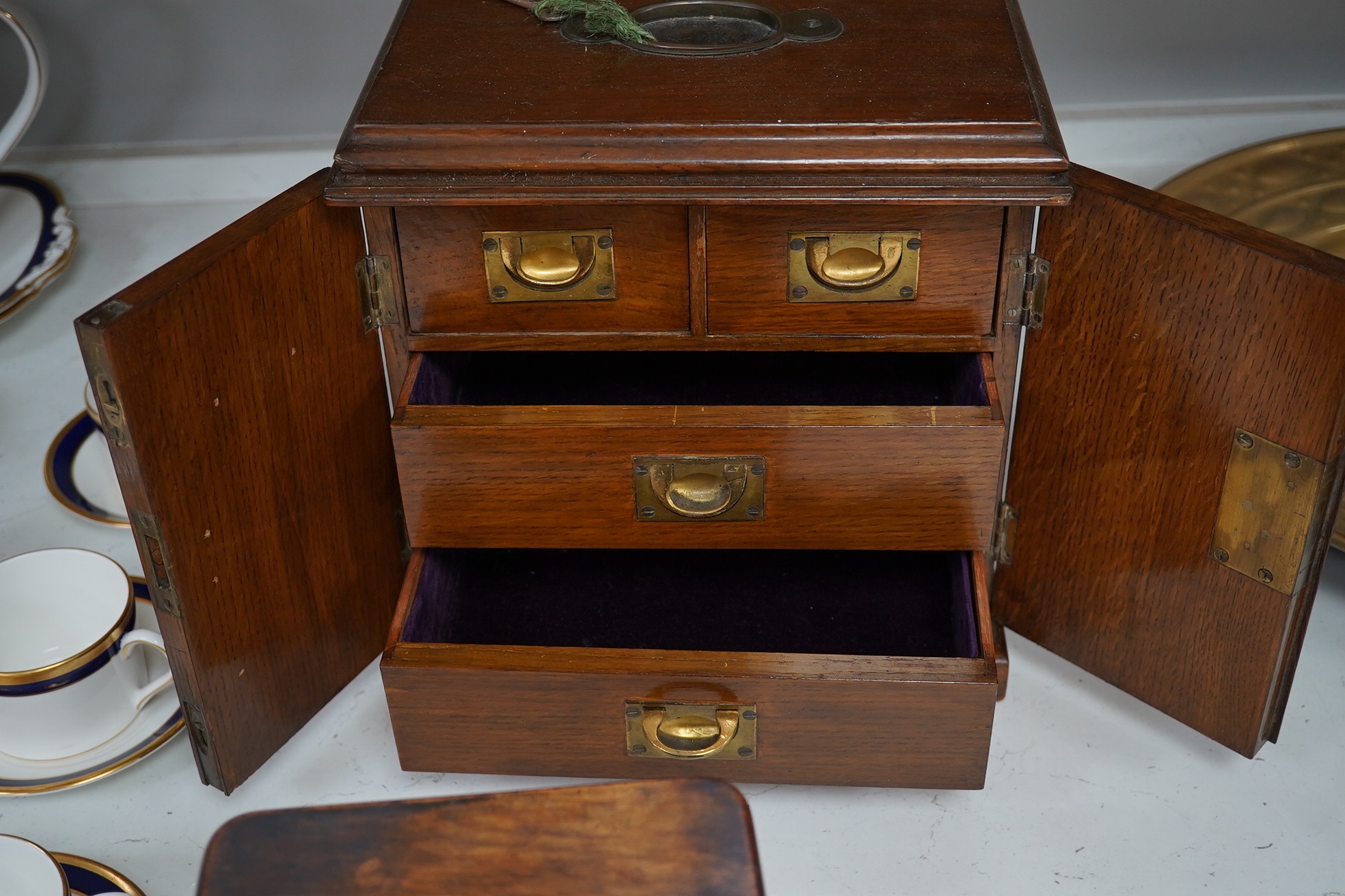 A Victorian oak two door, four drawer, vertu cabinet, with brass drawer military style handles and walnut timepiece, 29cm high, 28cm wide. Condition - fair to good